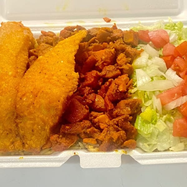 A takeout container filled with golden-fried fish, seasoned chicken, and a side of fresh salad.